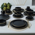 20-teiliges Tafelservice in Schwarz/Gold aus Steingut