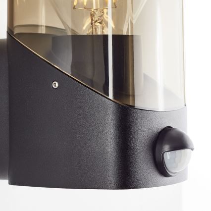 Brilliant - Applique da esterno con sensore MINOU 1xE27/10W/230V IP44 nero/fumé